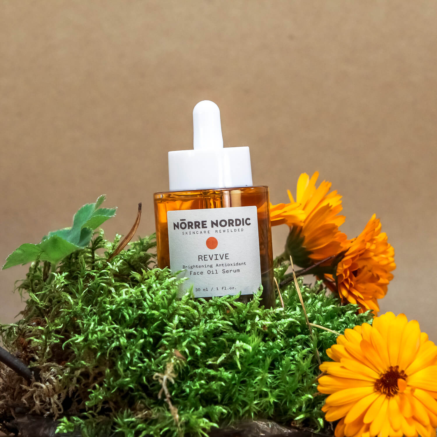 REVIVE Brightening Antioxidant Face Oil 30 ml amber glass bottle with dropper and label showing wild Arctic botanicals handmade in Finland